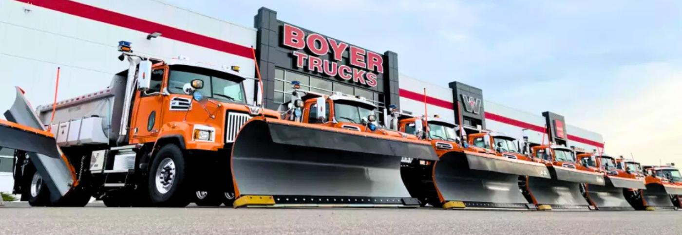 A Lineup of Western Star Snow Plows in Front of Boyer Trucks in St. Michael, MN