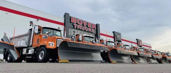 A line of Western Star Snow Plow Trucks in front of Boyer Trucks in St. Michael, MN.